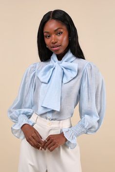 Cultivate an elegant yet dreamy look with the Sister Jane Wind River Light Blue Poet Sleeve Bow Collar Button-Up Top! Ethereal, semi-sheer woven fabric has a subtle sheen throughout as it shapes long, poet-style sleeves with gathered shoulders, smocking at the wrists, and flaring, ruffled cuffs. Collared neckline has an optional sash, for an oversized necktie-style bow. Bodice has a functional button placket at front, with rhinestone buttons for a little extra sparkle. Fit: This garment fits tru Outfits Pastel, Poet Sleeve, Wind River, Sister Jane, Bow Collar, Mesh Sleeves, Blue Bow, Going Out Outfits, Tops Fall