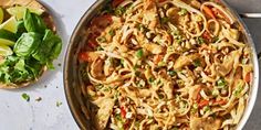 a pan filled with noodles and vegetables on top of a table