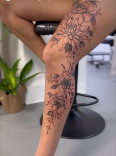 a woman's leg with flowers on it and the words, how do you get tattoos?