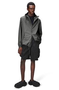 This lightweight, waterproof jacket with a longline silhouette keeps minimalism at the forefront as it keeps you dry. A hood with a built-in cap, an adjustable hemline and underarm eyelets bring comfort and breathability to the design that closes with a two-way, waterproof zipper. 30" length (size Medium) Hidden two-way front-zip closure Drawstring hood Long sleeves with elastic cuffs Unlined 100% polyester Machine wash, dry flat Imported Modern Hooded Raincoat For Spring, Modern Waterproof Raincoat For Spring, Casual Nylon Parka For Rainy Season, Spring Functional Waterproof Windbreaker, Casual Waterproof Nylon Raincoat, Urban Waterproof Outerwear For Spring, Casual Nylon Waterproof Raincoat, Casual Nylon Raincoat For Rainy Weather, Casual Windbreaker With Drawstring Hood In Recycled Polyester