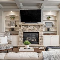 a living room filled with furniture and a flat screen tv mounted above a fire place