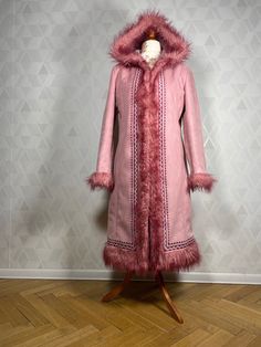 Cute 70s afghan hippie vegan coat finished with decorative embroidery.  This pink coat really looks impressive - it's an interesting pink color, decorated with artificial fur. The coat has two side pockets, is fastened with hooks and lined with artificial fur. There is no damage, stains, scratches, no unpleasant odors. Size: M/L Dimensions: collar sleeve:71 cm armpit sleeve:43 cm bust:2x51 cm in waist:2x49 cm in the hips:2x52 cm total length: 100 cm Our mannequin is size M. Pink Hooded Fur Coat With Faux Fur Trim, Spring Hooded Faux Fur Coat, Fitted Hooded Fur Coat For Winter, Fitted Pink Fur Coat With Long Sleeves, Bohemian Long Sleeve Fur Coat For Fall, Pink Fitted Long Sleeve Fur Coat, Bohemian Outerwear With Faux Fur Lining And Long Sleeves, Bohemian Outerwear With Faux Fur Lining, Fitted Pink Fur Coat For Fall