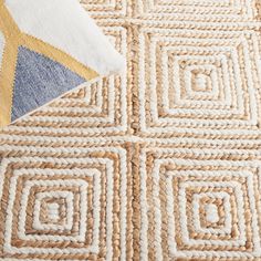 an area rug with various colored squares on it and a blue, yellow and white design