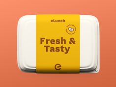 an orange and white lunch box with the words fresh & tasty on it