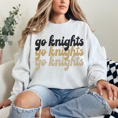 UCF Sweatshirt | UCF Merch | UCF Knights Sweatshirt | UCF Gift | UCF Alumni Gift  Are you looking for a University of Central Florida Sweatshirt for yourself or a UCF student/alumni in your life? This sweatshirt is perfect and comfortable for all occasions. Ideal for any situation, a unisex heavy blend crewneck sweatshirt is pure comfort. These garments are made from polyester and cotton. This combination helps designs come out looking fresh and beautiful. The collar is ribbed knit, so it retain Oversized School Spirit Graphic Sweatshirt, Oversized School Spirit Sweatshirt With Graphic Print, Oversized Graphic Print Sweatshirt For School Spirit, White College Sweatshirt With Slogan, White School Spirit T-shirt For Winter, White Sweatshirt With Letter Print For Fans, Florida Sweatshirt, Alumni Gifts, Ucf Knights