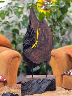 a piece of wood sitting on top of a wooden table next to a brown chair