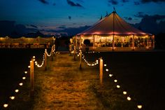 a large tent with candles lit up in front of it