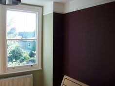 an empty room with a radiator and window