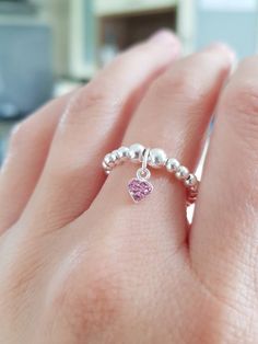 Fabulous handmade Sterling Silver Stretch Ring. They look great alone or with other stacker rings.  It would be a perfect gift or for a treat for yourself.  ⭐ 3mm Sterling Silver Beads ⭐ 5mm Sterling Silver Pink CZ Heart Charm  The ring measures Medium size 6.5cm, which will fit most fingers. Need a specific size, no problem. Simply drop me a message with the size and I can make one up for you.   Measuring your ring finger: wrap a length of cotton around the finger where you would like the ring Stackable Sterling Silver Open Heart Ring, Sterling Silver Stackable Open Heart Ring, Pink Sterling Silver Stackable Jewelry, Adjustable Pink Sterling Silver Stackable Rings, Pink Adjustable Sterling Silver Stackable Rings, Sterling Silver Stackable Crystal Promise Ring, Pink Sterling Silver Stackable Promise Rings, Stacker Rings, Stretch Ring