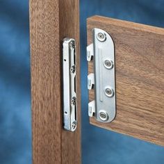 an image of a wooden door handle with metal latches on the front and side