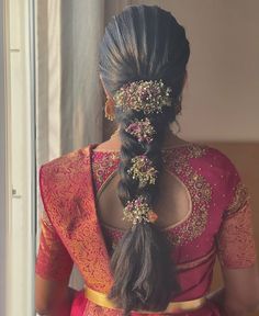 a woman with long hair in a pink sari and gold jewelry on her head