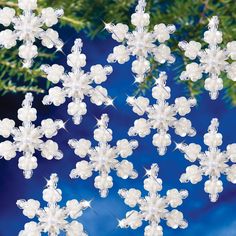 snowflakes are hanging from a christmas tree