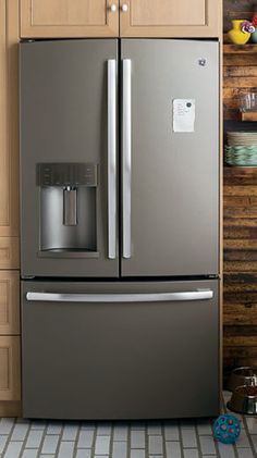 a stainless steel refrigerator with ice and water dispenser in a kitchen setting