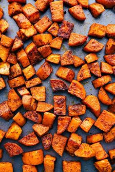 roasted sweet potatoes on a baking sheet ready to be cooked in the oven for dinner