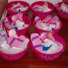 several pink buckets filled with different types of items