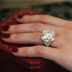 a woman's hand with a diamond ring on it