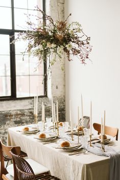 the table is set with candles and plates