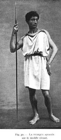 an old black and white photo of a man in roman garb holding a staff