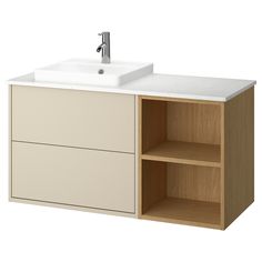 a white sink sitting next to a wooden cabinet