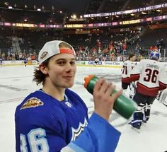 a hockey player holding a bottle in his right hand