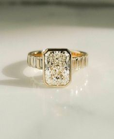 a diamond ring sitting on top of a table