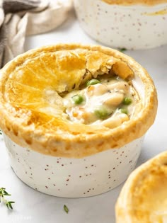 two white dishes filled with chicken pot pies