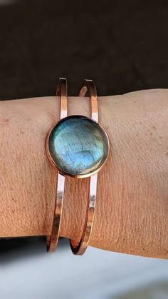 Naturally mined blue multi fire laborite ships fast first-class free shipping. You will love this adorable boho hippie vibe gorgeous blue and green multi-fire large labradorite cuff bracelet. The multi-color changing hues will keep you memorized. You will sure to get noticed while wearing this striking large labradorite cuff. has easy to open front spring clasps is lightweight and comfortable to wear. labradorite is considered one of the most powerful protectors. The gemstone creates a shield fo Handmade Bohemian Round Cuff Bracelet, Adjustable Labradorite Cuff Bracelet As Gift, Bohemian Rose Gold Round Jewelry, Adjustable Cabochon Bohemian Bracelets, Bohemian Round Labradorite Bracelets, Bohemian Adjustable Bracelets With Cabochon, Bohemian Bracelets With Cabochon, Adjustable Copper Cuff Bracelet, Adjustable Round Copper Cuff Bracelet