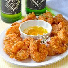 a white plate topped with fried shrimp and dipping sauce