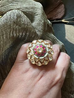 A statement ring with a beautiful and intricate design with Kundan stones. Size: Adjustable Statement Rings Gold, Wedding Rings With Intricate Metal Design, Metal Toe Ring Crystal Wedding Ring, Jeweled Open Ring For Wedding, Wedding Jeweled Open Ring, Fusion Style Wedding Ring With Intricate Design, Unique Jeweled Rings For Wedding, Kundan Rings, Kundan Ring