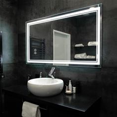 a bathroom sink sitting under a large mirror