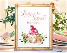 there is a sign that says love is sweet and a cupcake