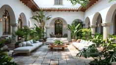 an outdoor living area with couches and potted plants