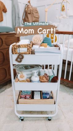 a white cart filled with lots of baby items on top of a carpeted floor