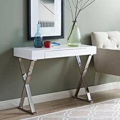 a white desk with two vases on it