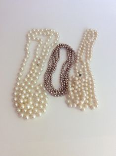 "This classic faux pearl collection is perfect for a timeless lady. Wear the strands alone or layered together. Pop one on and make a lunch date with your gal pals. The small smokey pink strand does not have a clasp and measures 30\". The medium cream beads hav a clasp and measure 30.25\". The largest bead necklace has an inset clasp and measures 32\". Each shows minor signs of age and wear. All are faux and are made of plastic. Shipping is included in the price. (Shipping may be listed as free- Classic Single Strand Beaded Necklace For Parties, Classic Multi-strand Pearl Necklace For Party, Lady Necklace, Fancy Lady, Multi Strand Pearl Necklace, Large Bead Necklace, Vintage Veils, Art Nouveau Pendant, Vintage Beads Necklace