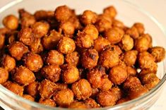 a glass bowl filled with fried food on top of a table