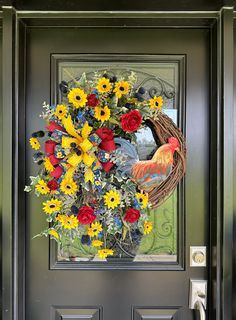 a front door with a wreath decorated with flowers and a rooster on it's side