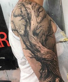 a man with a tree tattoo on his arm