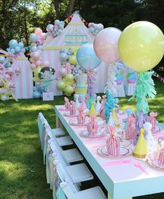 a table set up with balloons and other decorations