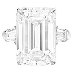 This stunning GIA certified ring showcases a 10.06-carat emerald cut diamond, set in luxurious platinum for a timeless, elegant look. With an F color grade, the diamond displays a near-colorless brilliance, while its VS1 clarity ensures only minor inclusions that are invisible to the naked eye. The diamond's excellent polish and symmetry reflect its superior craftsmanship, maximizing its radiant sparkle. Complemented by tapered baguette diamonds on either side, the ring offers a balanced and ref Emerald Cut Diamond Engagement, Contemporary Engagement Rings, Emerald Cut Diamond Ring, Platinum Diamond Rings, Modern Engagement Rings, Engagement Ring Diamond Cut, Contemporary Ring, Emerald Cut Diamond, Platinum Engagement Rings