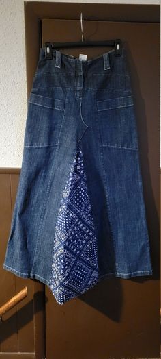 a blue skirt hanging on a clothes rack