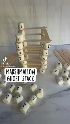 the marshmallow ghost stack is made from wood and has black dots on it