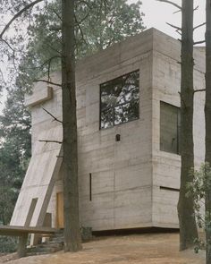 a house in the woods with stairs leading up to it