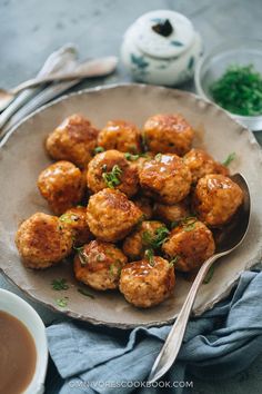 a plate full of meatballs covered in sauce