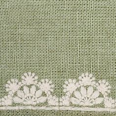 an embroidered piece of cloth with flowers on it