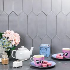 a table topped with plates and cups filled with food