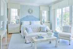 a bedroom with blue and white decor in it