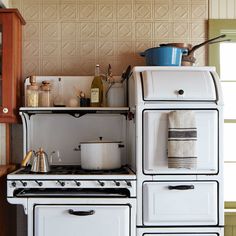 an old fashioned white stove in a kitchen