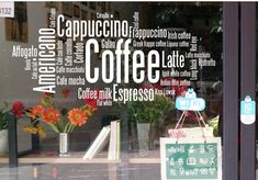 there is a sign in the window with words written all over it that say coffee