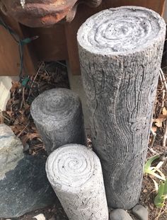 three logs sitting next to each other on the ground